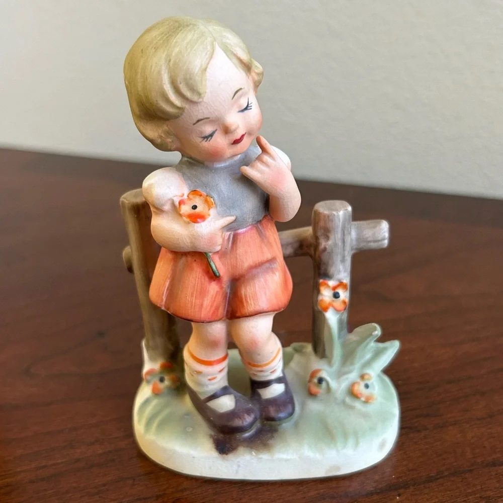 Vintage Arnart girl against a fence porcelain figurine